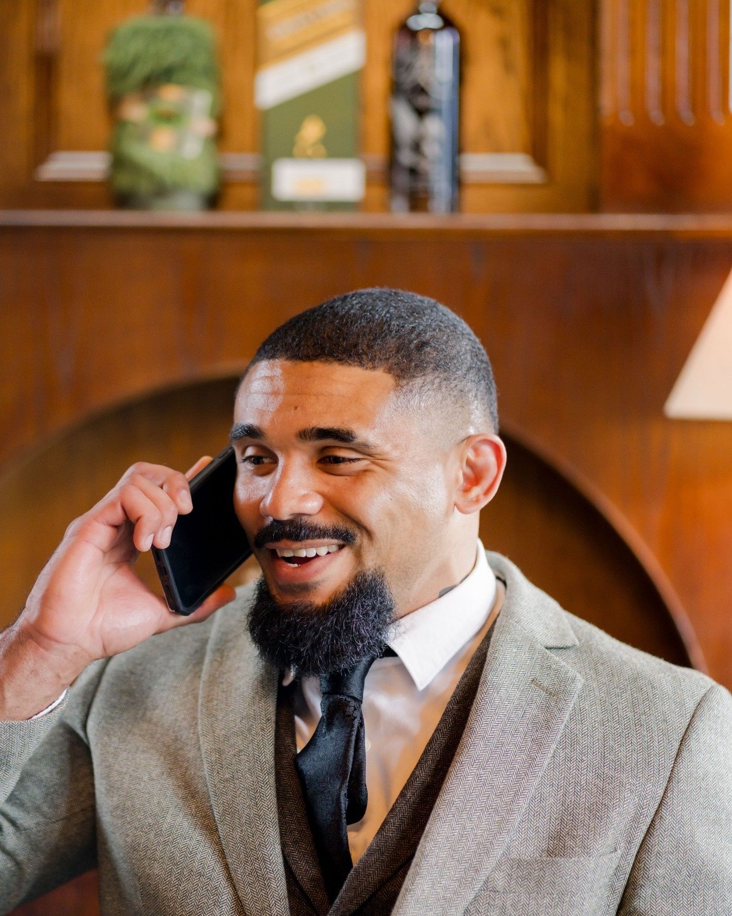 Joe smiling while taking a phone call
